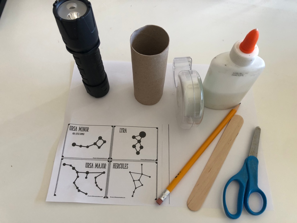 You will need: a flashlight, a toilet paper tube, tape, glue, scissors, sharp pencil, popsicle stick for spreading glue (optional) and constellation printable.
